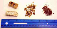 Photo showing 3 different grades of vermiculite and a ruler to indicate grain size