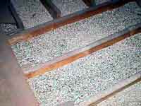 Close up photo of vermiclulite insulation installed in an attic